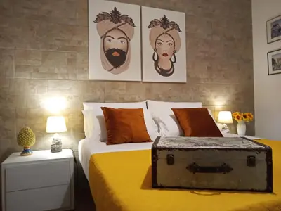 a bedroom with a bed with an old trunk on it at Zisa Home ai Cantieri Culturali con Patio Privato - vicino centro storico - No ZTL in Palermo