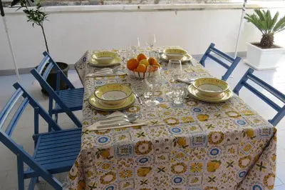 a table with plates and bowls of fruit on it at Sofi apartment in Palermo