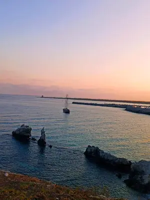a sail boat in the water at sunset at A casa di nonna Maria in Terrasini