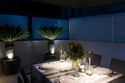 a dining room with a table with plates and plants at Dc Domus Charme SPA in Palermo