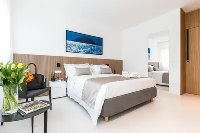 a bedroom with a bed and a table with a chair at Dc Domus Charme SPA in Palermo