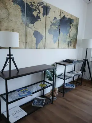 a room with two tables and a map on the wall at GuestHost - Residenza dei Poeti - Roomy and Modern Flat in Palermo