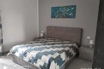 a bedroom with a bed with a blue and white quilt at Home sweet home appartamento ricco di comfort in Palermo