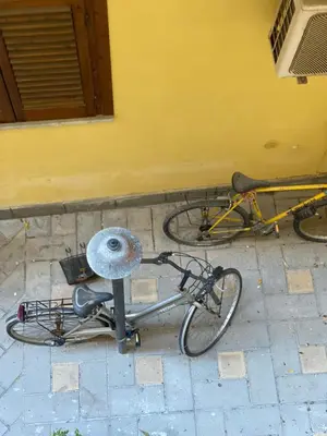 a bike laying on the ground next to a building at Apartament la Lumaca Kalsa in Palermo