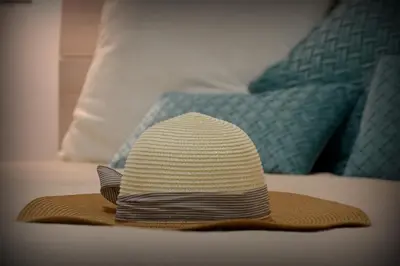 a hat sitting on top of a bed at PESCA AZZURRA in Terrasini