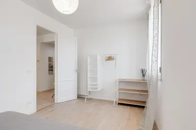 a white room with a bed and a mirror at GuestHost - BallarHost - Ballarò Market Terrace Apartment in Palermo