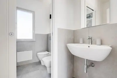 a bathroom with a sink and a toilet at GuestHost - BallarHost - Ballarò Market Terrace Apartment in Palermo