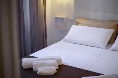 a bed with two towels sitting on top of it at HouseStation in Palermo