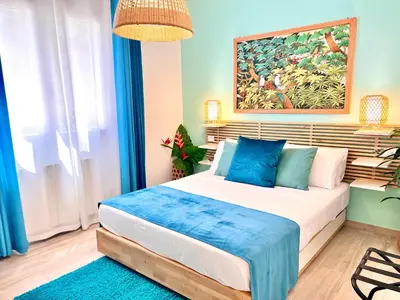 a bedroom with a bed with a painting on the wall at Golden Holiday Villas Private Pools in Sicily in Terrasini