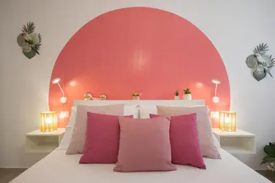 a pink bedroom with a bed with pink pillows at Golden Holiday Villas Private Pools in Sicily in Terrasini