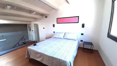 a bedroom with a bed in a white room at Le dimore di Palagonia in Bagheria