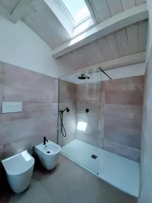 a bathroom with a shower and a toilet and a sink at Le dimore di Palagonia in Bagheria
