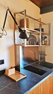 a kitchen with a sink and a black counter top at Le dimore di Palagonia in Bagheria