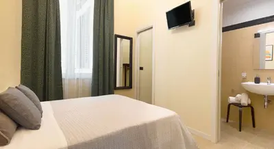 a hotel room with a bed and a sink at Antista Rooms in Palermo