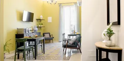a kitchen and dining room with a table and chairs at Antista Rooms in Palermo