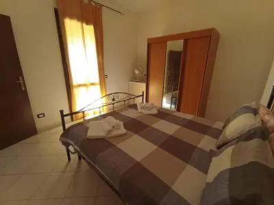 a bedroom with a bed with towels on it at Sandro Apartment in Castellammare del Golfo