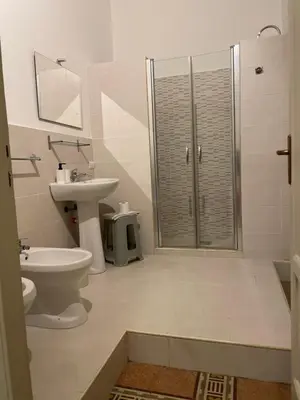 a bathroom with a shower and a toilet and a sink at 100 PASSI al Massimo in Palermo