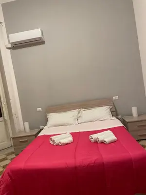 two towels on a bed with a red blanket at 100 PASSI al Massimo in Palermo