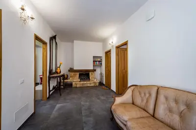 a living room with a couch and a fireplace at Villa Michelangelo in Castellammare del Golfo