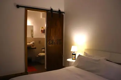 a bedroom with a bed and a bathroom with a toilet at Casavacanze Tuttapposto in Palermo