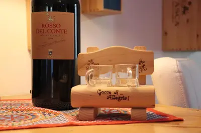 a bottle of wine and a glass on a table at Casavacanze Tuttapposto in Palermo