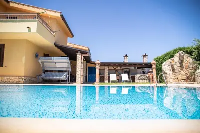 a swimming pool in front of a house at Dimora Fanale, Villa Esclusiva con Piscina Privata - Fanale Rentals in Altavilla Milicia
