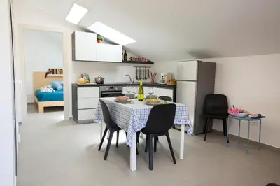 a kitchen and dining room with a table and chairs at Appartamento Limone in Splendida villa Nature al mare di Scopello Zingaro in Scopello