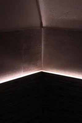a corner of a room with a light on the wall at Tufoletto Apartment in Palermo