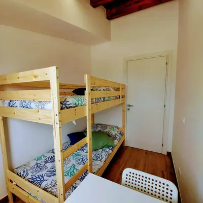 two bunk beds in a room with a bed at Terrazza del Golfo in Castellammare del Golfo