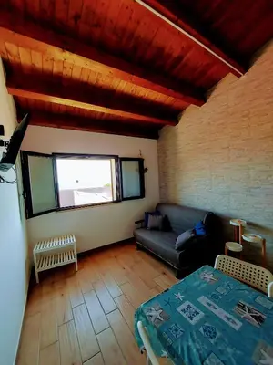 a living room with a couch and a table at Terrazza del Golfo in Castellammare del Golfo