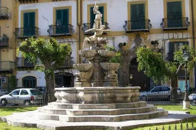 a large fountain in front of a building at Piazza Marina Apartment in Palermo