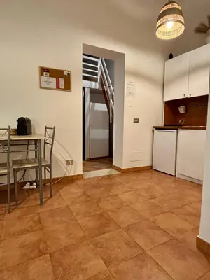 a kitchen and dining room with a table and a counter at Piazza Marina Apartment in Palermo