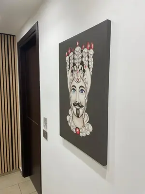 a painting of a mask on a wall at Kristal in San Vito lo Capo