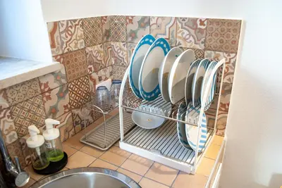 a kitchen with plates and dishes on a wall at La casa di Nemi a San Vito in San Vito lo Capo