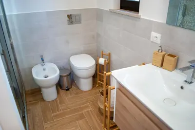 a bathroom with a toilet and a sink at La casa di Nemi a San Vito in San Vito lo Capo