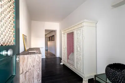 a living room with a cabinet and a hallway at Celestre all'Alloro by DomuSicily in Palermo