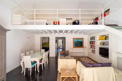 a living room with a table and a couch at Celestre all'Alloro by DomuSicily in Palermo