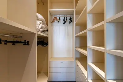 a walk in closet with white shelves at Celestre all'Alloro by DomuSicily in Palermo