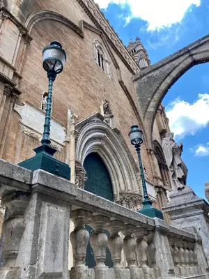 a building with two street lights in front of it at Cathedral Sweet home in Palermo
