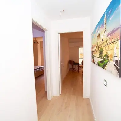 a room with a hallway with a painting on the wall at Delle Palme Rooms elegante monolocale in centro in Palermo