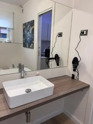 a bathroom with a white sink and a mirror at Delle Palme Rooms elegante monolocale in centro in Palermo
