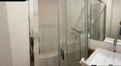 a bathroom with a glass shower and a sink at Delle Palme Rooms elegante monolocale in centro in Palermo