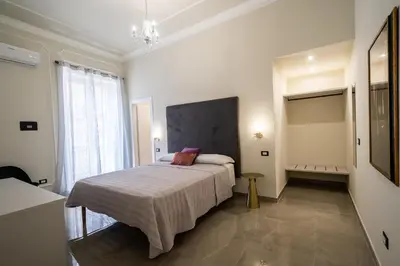 a bedroom with a bed in a room with a window at Amaris in Palermo