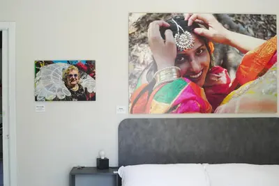 a picture of a woman on a poster on a wall at Click Art & Room in Trabia