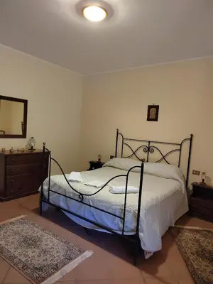 a bedroom with a bed and a dresser and a mirror at Casa vacanze BY THE SEA in Trabia