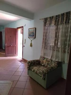 a living room with a couch and a window at Casa vacanze BY THE SEA in Trabia