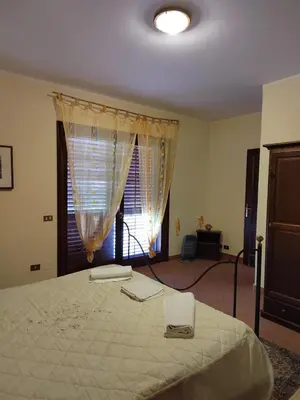 a bedroom with a large bed and a window at Casa vacanze BY THE SEA in Trabia