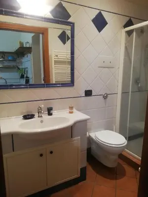 a bathroom with a sink and a toilet and a mirror at Palermo Centrocittà in Palermo