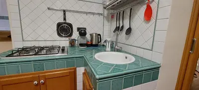 a small kitchen with a sink and a stove at Palermo Centrocittà in Palermo