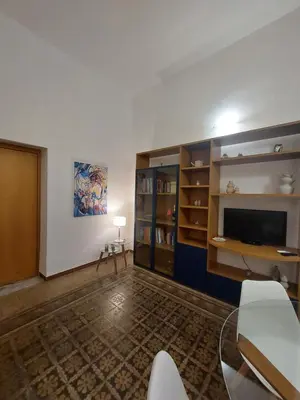 a living room with a television and a table and chairs at Palermo Centrocittà in Palermo
